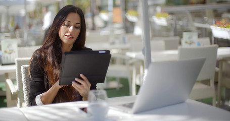 Image showing Attractive businesswoman using a tablet pc