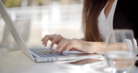 Image showing Businesswoman typing on a laptop computer