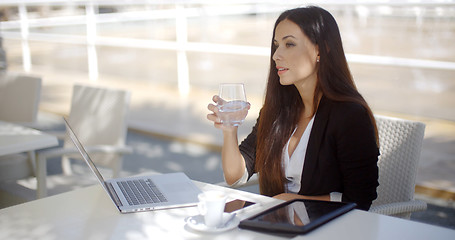 Image showing Businesswoman enjoying coffee at a restaurant