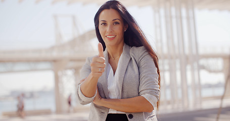 Image showing Motivated young woman giving a thumbs up