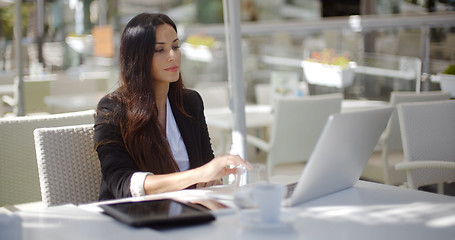 Image showing Businesswoman working at an open-air table