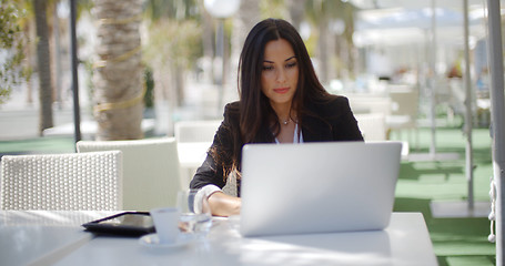 Image showing Businesswoman working at an open-air table