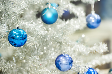 Image showing Blue baubles on silver artificial christmas tree