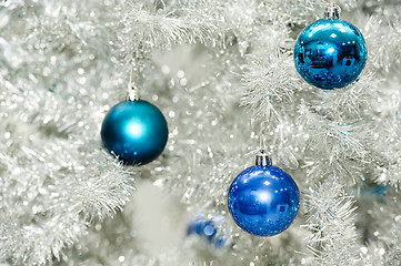 Image showing Blue baubles on silver artificial christmas tree