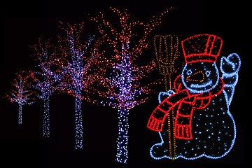 Image showing Illuminated Snowman and trees 