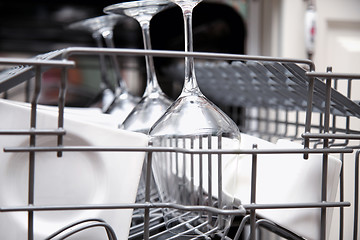 Image showing Open dishwasher with clean utensils