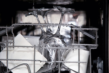 Image showing details of open dishwasher, utensils with drops in during washin