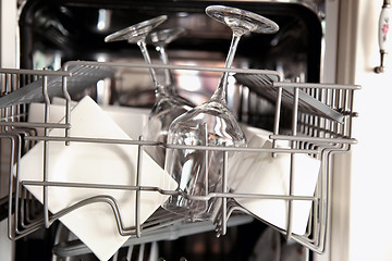 Image showing Open dishwasher with clean utensils