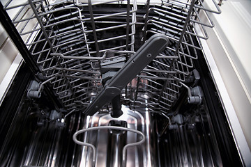 Image showing View of the interior of an empty opened dishwasher