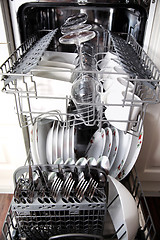 Image showing Open dishwasher with clean utensils