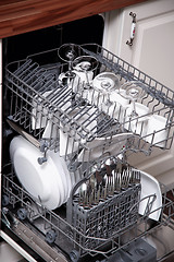 Image showing Open dishwasher with clean utensils