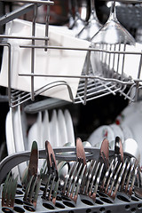 Image showing Open dishwasher with clean utensils