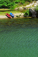 Image showing Kayaks on river bank