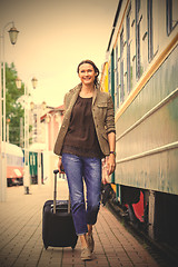 Image showing woman traveler with luggage walking on the platform