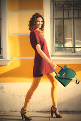 Image showing pretty woman with green handbag