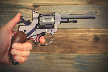 Image showing revolver gun in a human hand