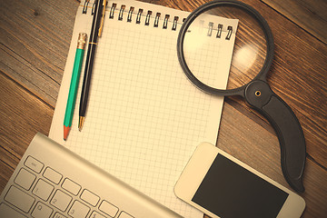 Image showing notebook, computer keyboard, pen, pencil and magnifying glass