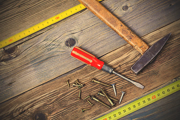 Image showing Vintage hammer, screwdriver, screws and measuring tape