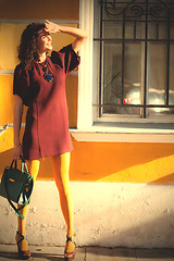 Image showing beautiful middle-aged woman in a burgundy dress 