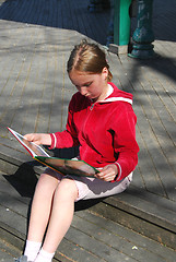 Image showing Young girl reading