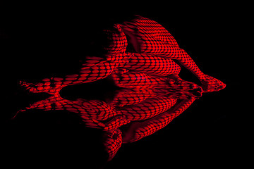 Image showing The  body of woman with red pattern and its reflection