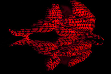 Image showing The  body of woman with red pattern and its reflection