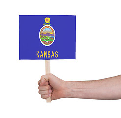 Image showing Hand holding small card - Flag of Kansas