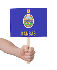 Image showing Hand holding small card - Flag of Kansas