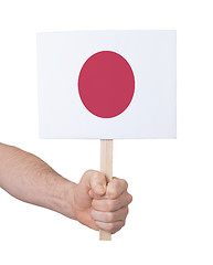 Image showing Hand holding small card - Flag of Japan