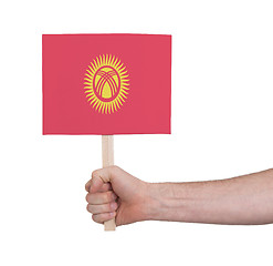 Image showing Hand holding small card - Flag of Kyrgyzstan