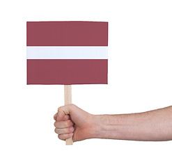 Image showing Hand holding small card - Flag of Latvia