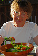 Image showing Happy eating senior woman