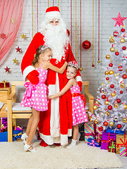 Image showing For children in the New Year\'s Eve Santa Claus came, they happily embrace it