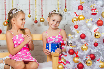 Image showing The girl gave her sister a Christmas gift