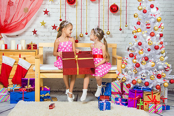 Image showing Joyful girl who gave a great gift at each other in a Christmas setting