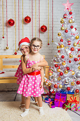 Image showing The girl hugged the other girl in funny round glasses