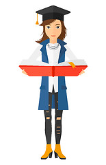 Image showing Woman in graduation cap holding book.