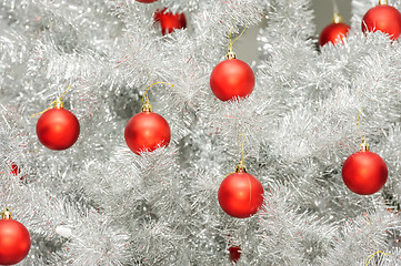 Image showing Red baubles on silver artificial christmas tree