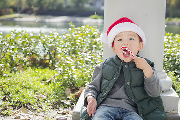 Image showing Cute Mixed Race Boy With Santa Hat and Candy Cane