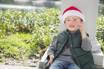 Image showing Cute Mixed Race Boy With Santa Hat and Candy Cane