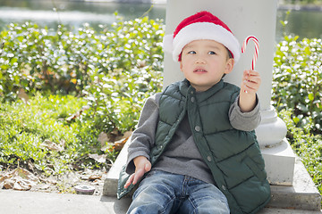 Image showing Cute Mixed Race Boy With Santa Hat and Candy Cane