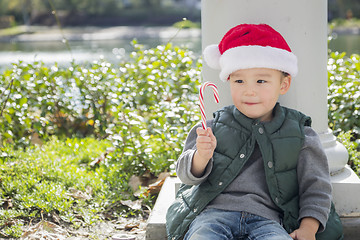 Image showing Cute Mixed Race Boy With Santa Hat and Candy Cane