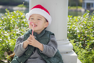 Image showing Cute Mixed Race Boy With Santa Hat and Candy Cane