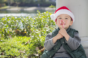 Image showing Cute Mixed Race Boy With Santa Hat and Candy Cane