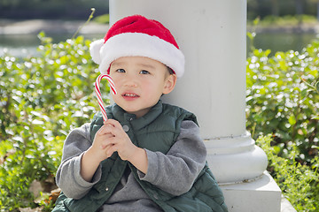 Image showing Cute Mixed Race Boy With Santa Hat and Candy Cane