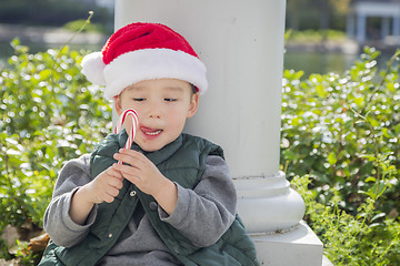 Image showing Cute Mixed Race Boy With Santa Hat and Candy Cane