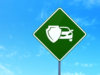 Image showing Insurance concept: Car And Shield on road sign background