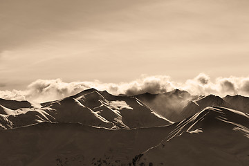 Image showing Sepia evening winter mountains and sunlight clouds