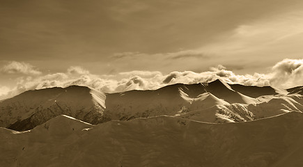 Image showing Sepia winter mountains at evening and sunlight clouds