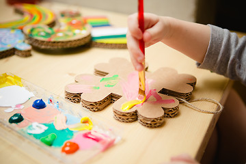 Image showing Little female baby painting with colorful paints